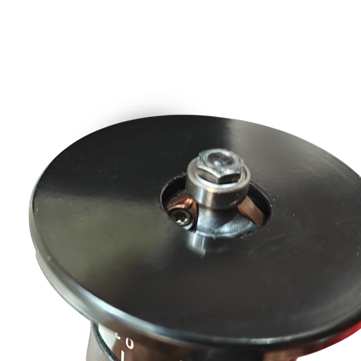 Close-up of a black circular object with a metallic center