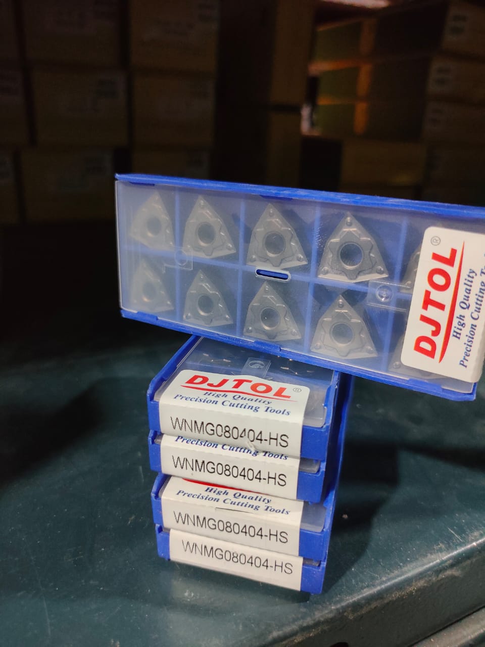 Box of DUTOL cutting tools on a dark surface