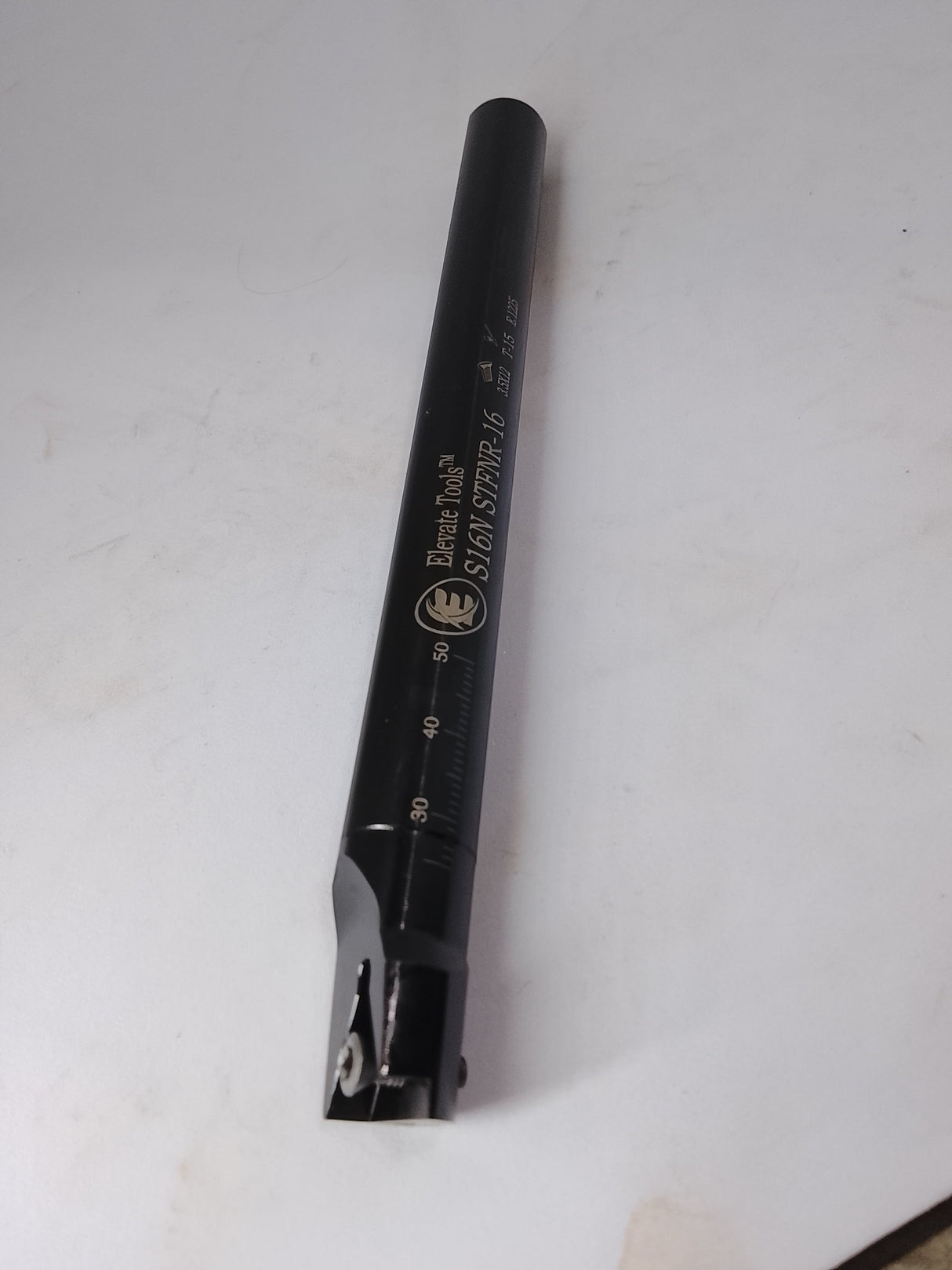 Black metal tool with measurement scale