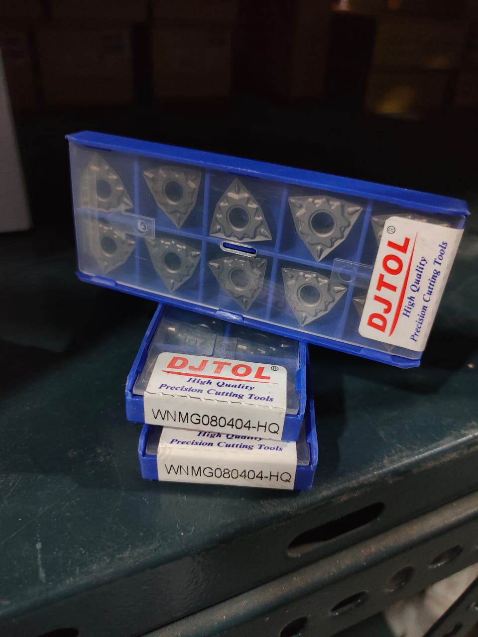 Blue toolbox with DJTOL-branded cutting tools