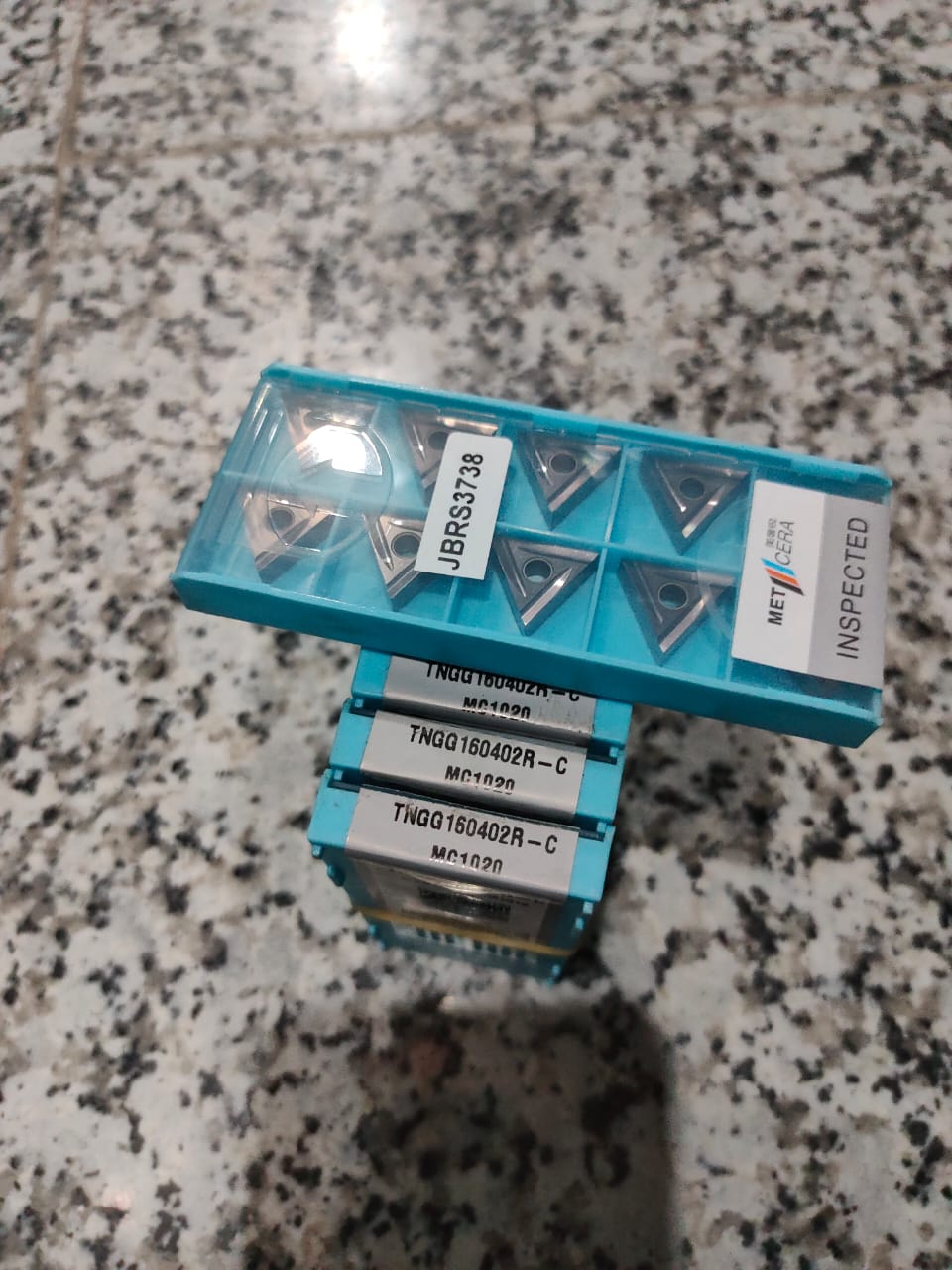 Metal cutting inserts in a blue holder