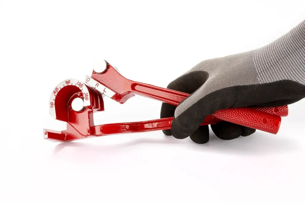Hand holding red manual tube bender