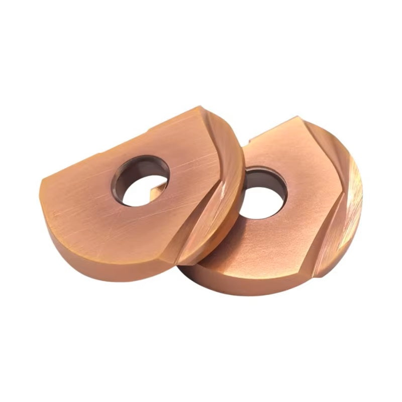 Two copper-colored lathe inserts