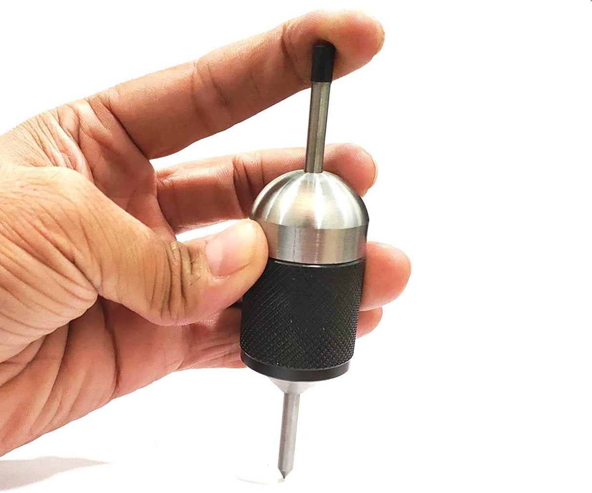 Hand holding universal spring-loaded transfer center punch tool with knurled grip sleeve
