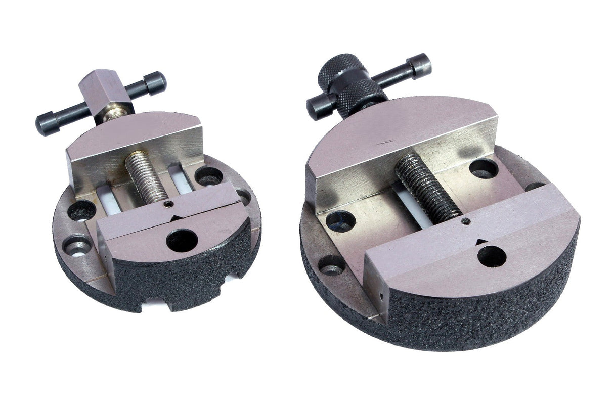 Two circular metal machine vises