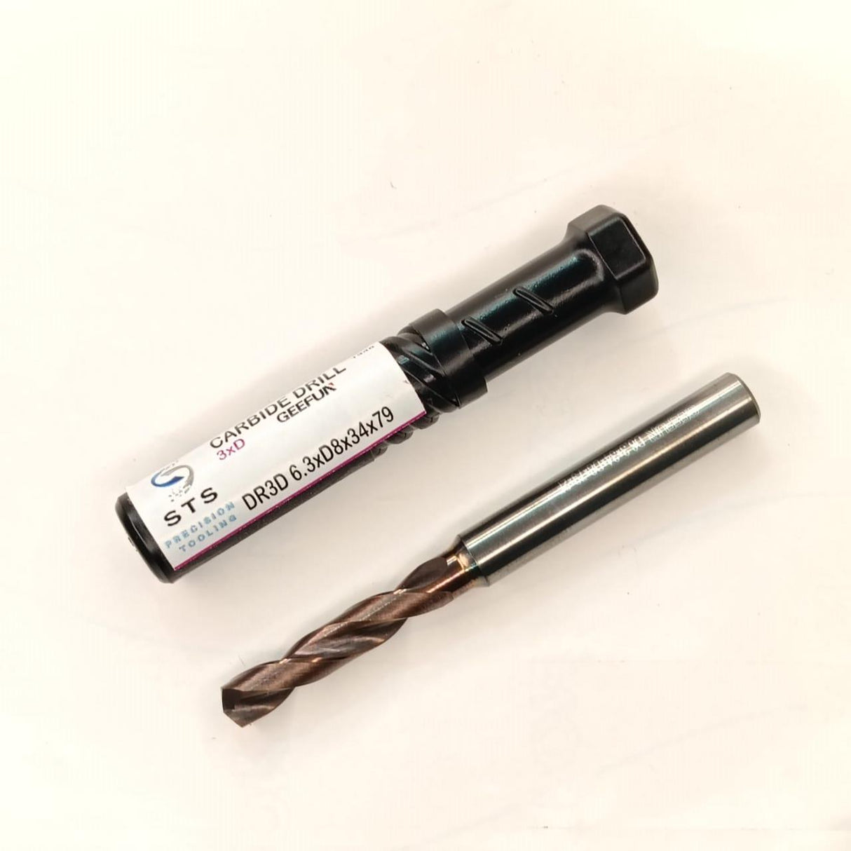 Cylindrical drill bit with packaging