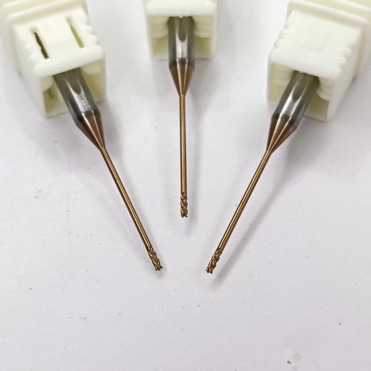 Three dental drill bits