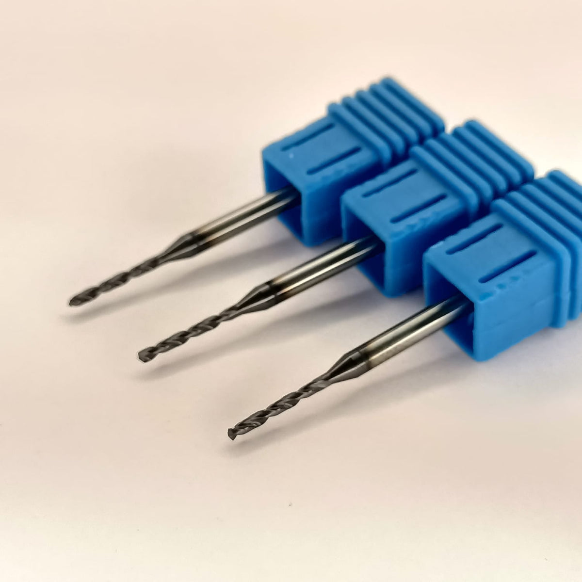 Three drill bits in blue holders