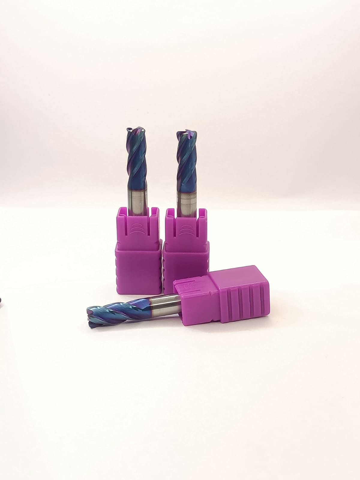 Three drill bits in purple holders