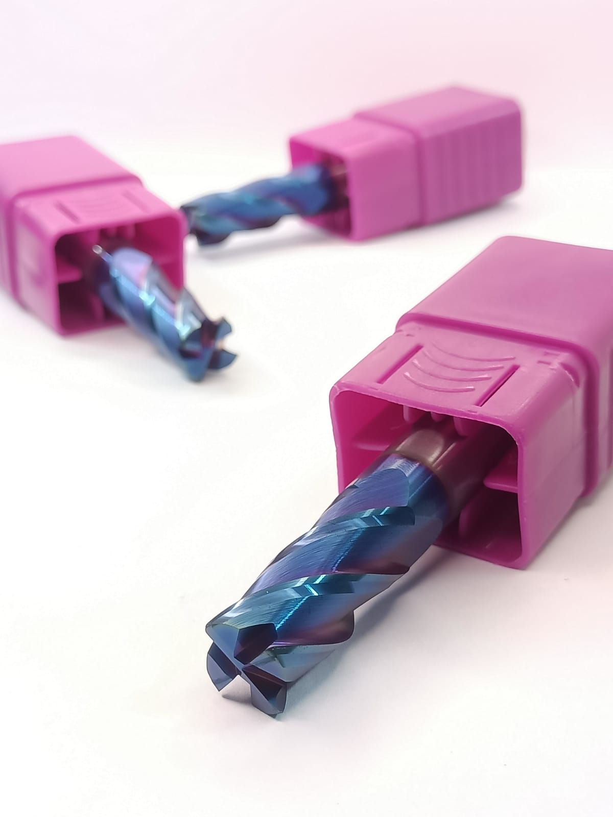 Two pink drill bits with blue cutting