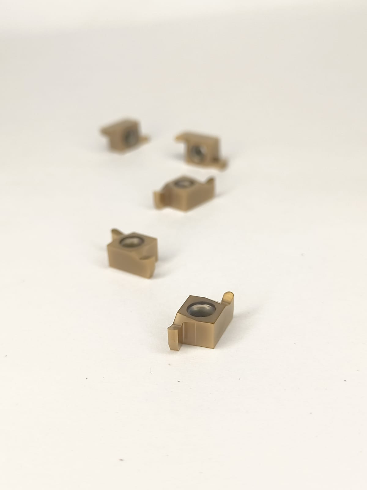 Five small brass mechanical components