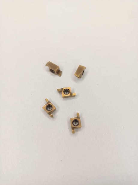 Five brass-colored metal components