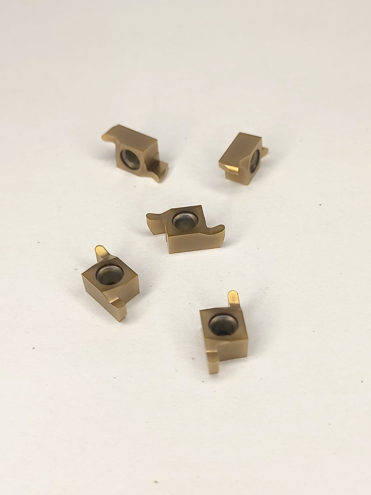 Five brass mechanical components