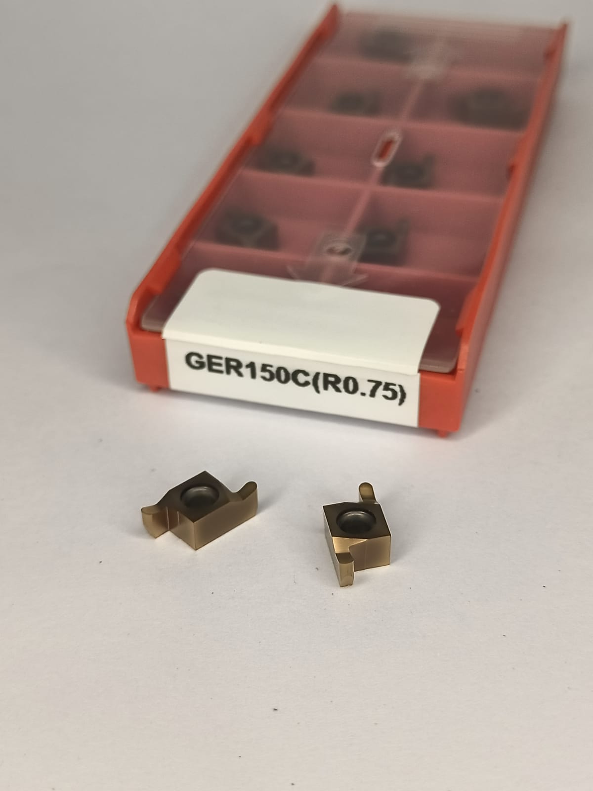 Two metal components with a red toolbox labeled