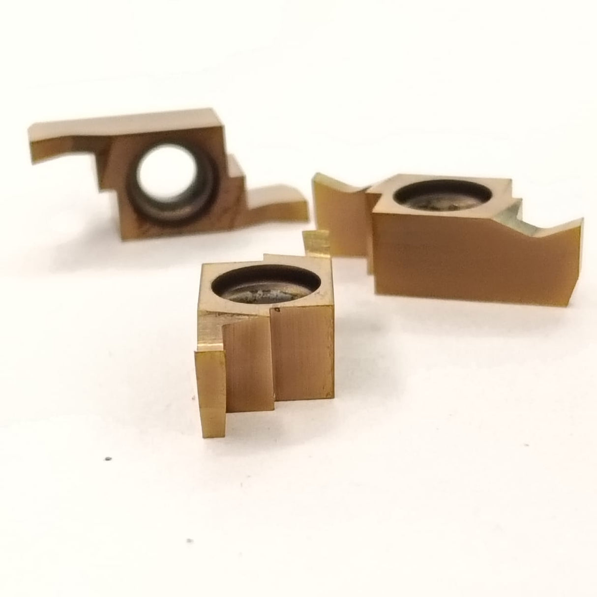 Three metallic cylindrical components