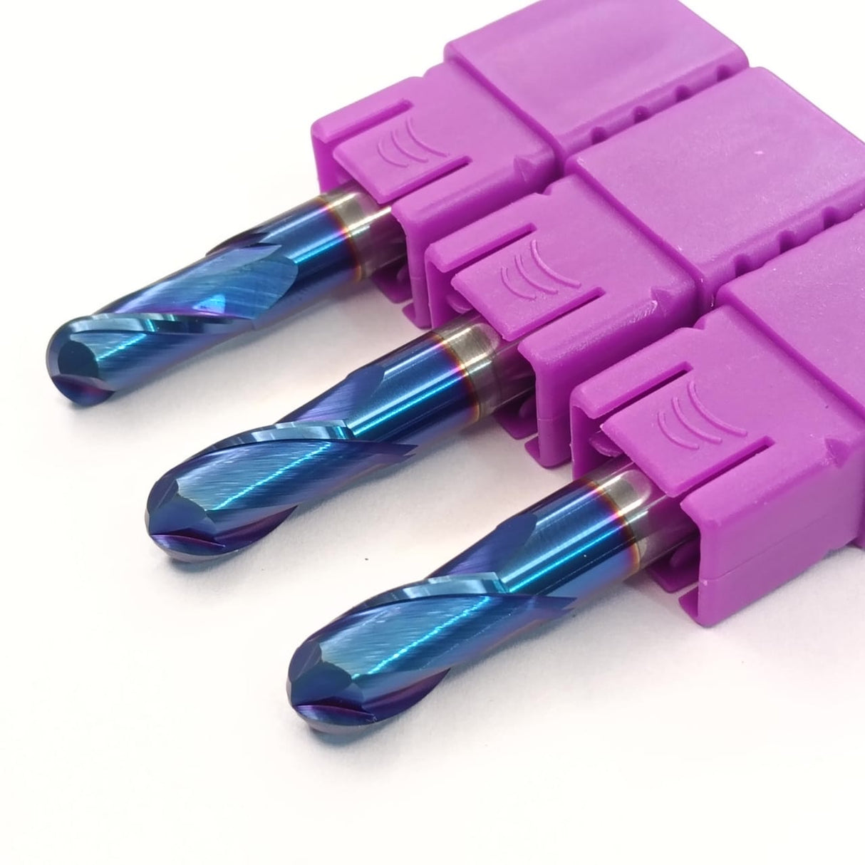 Three blue drill bits in a purple holder