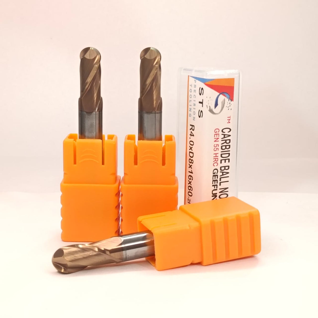 Two carbide drill bits in orange holders