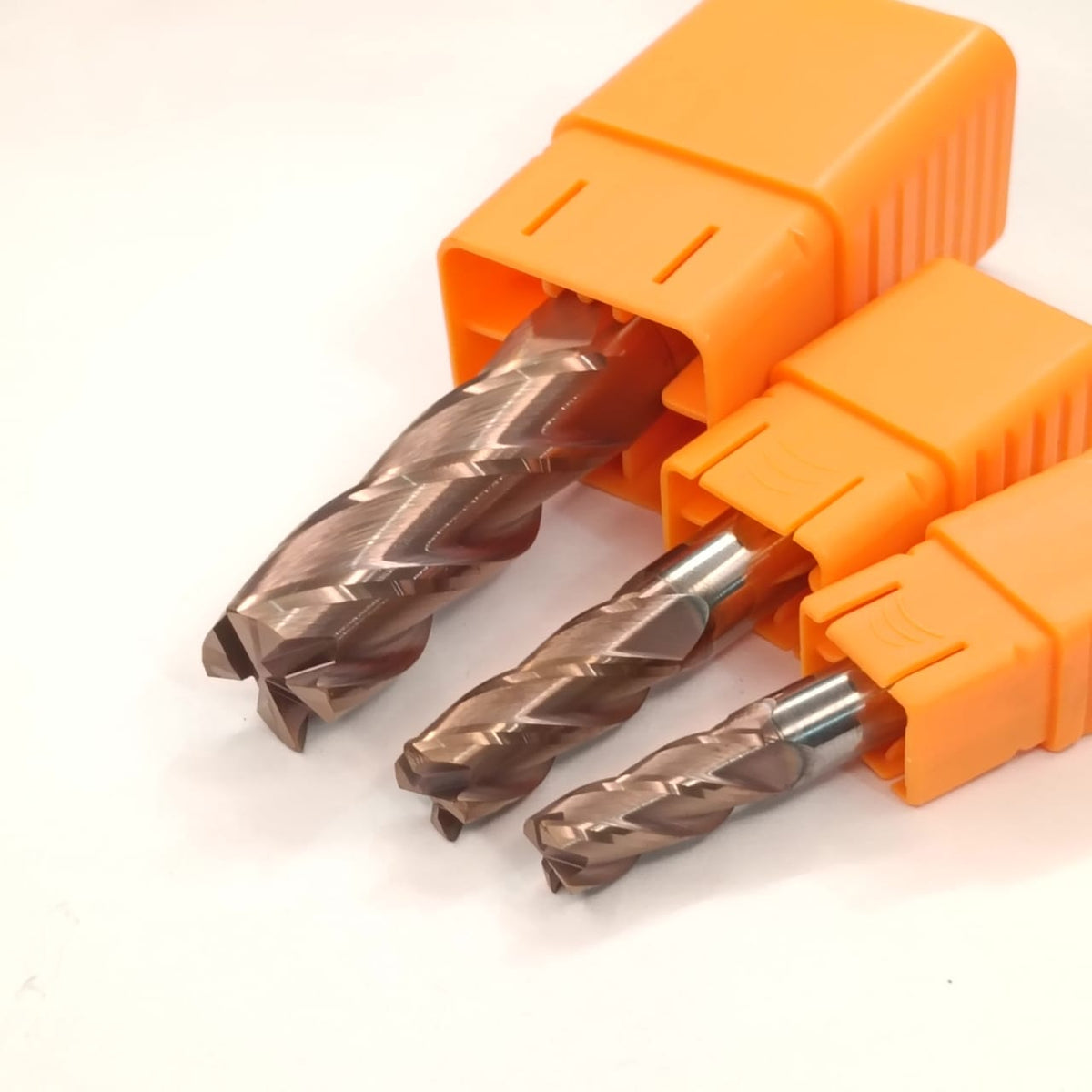 Three drill bits in an orange holder