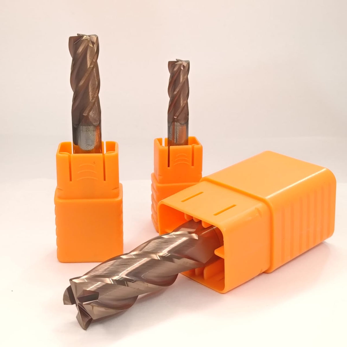 Three drill bits in orange holders