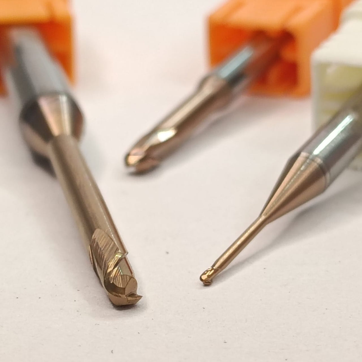 Metal drill bits on a white surface