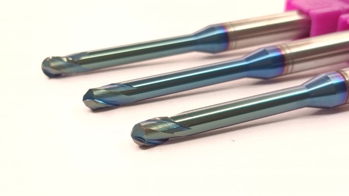 Three metal drill bits with blue and purple coatings