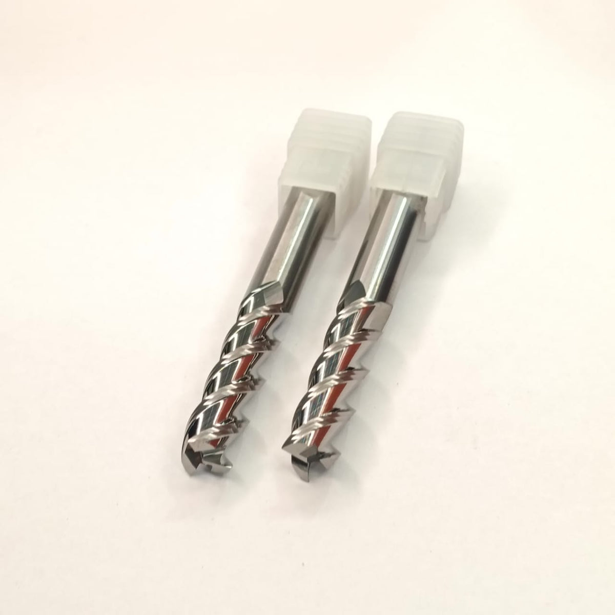 Two metal drill bits with white handles