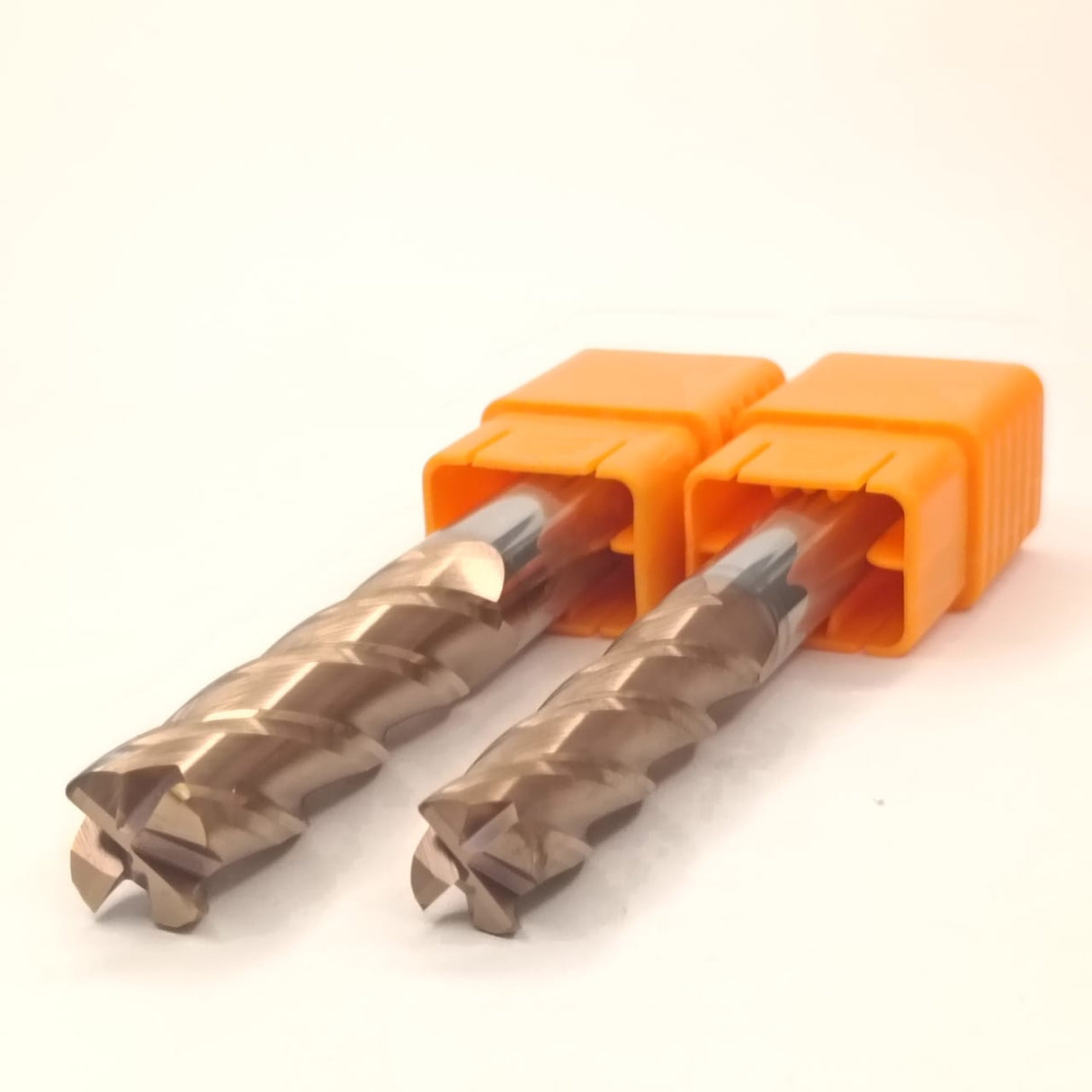 Two metal drill bits with orange holders