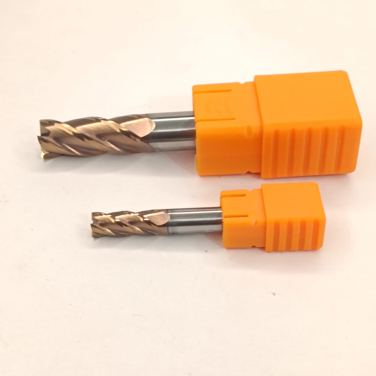 Two metal drill bits with orange handles
