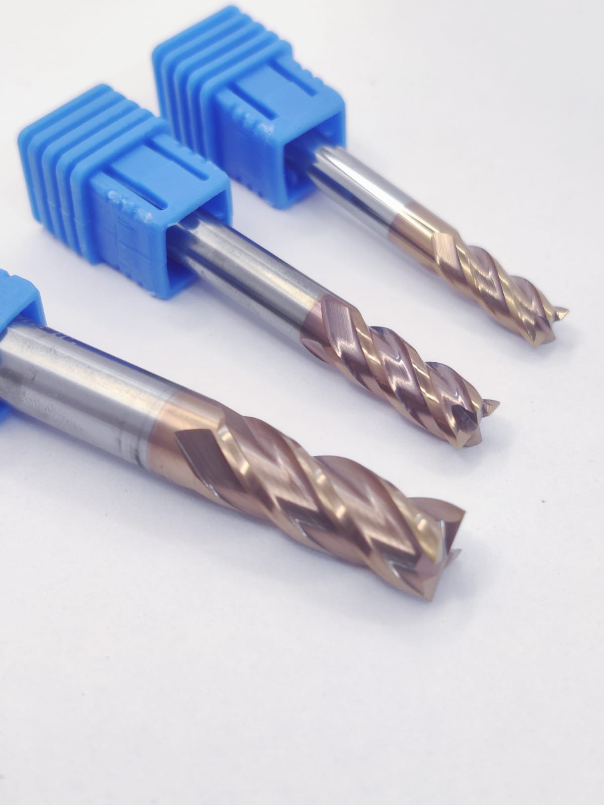 Three drill bits with blue handles