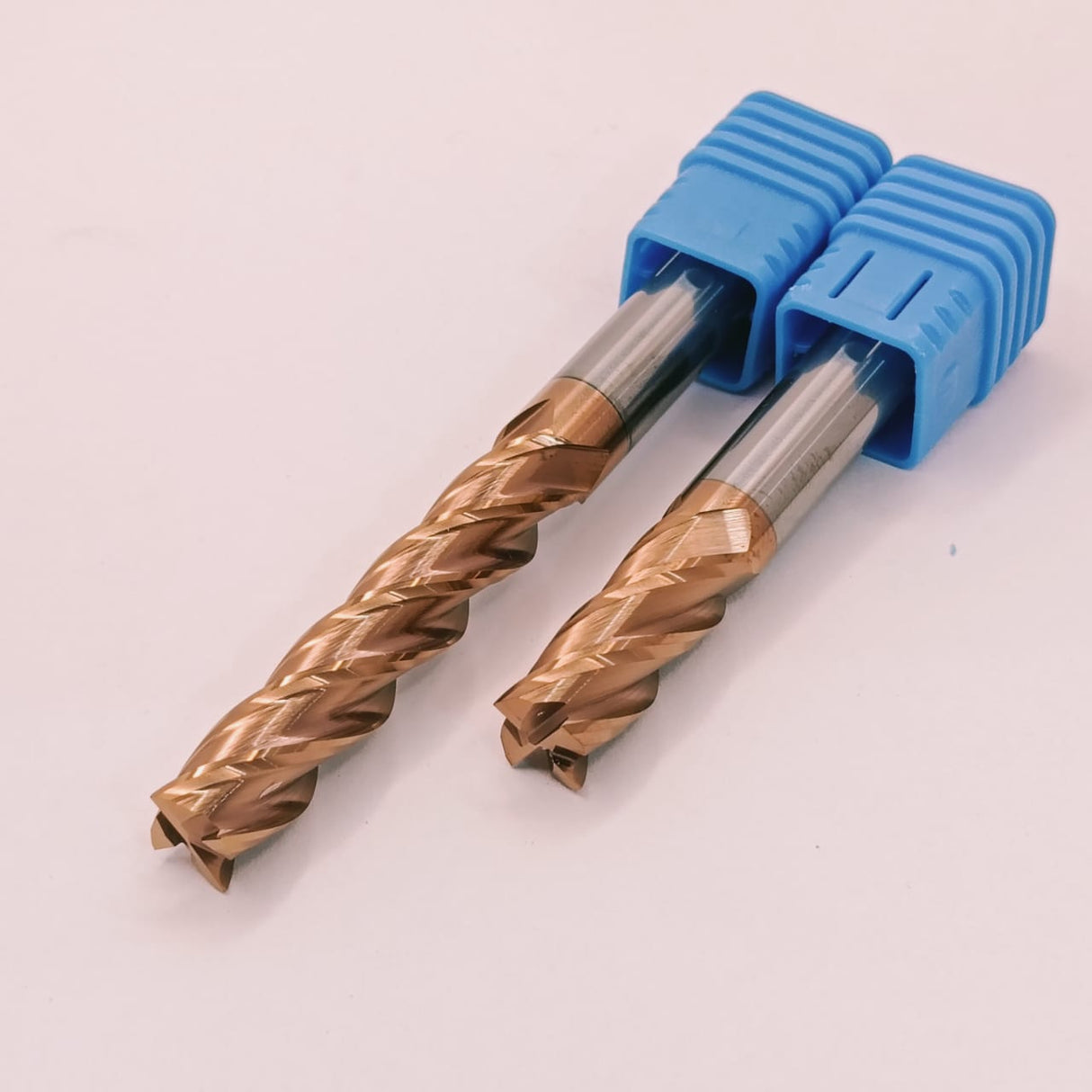 Two metal drill bits with blue handles