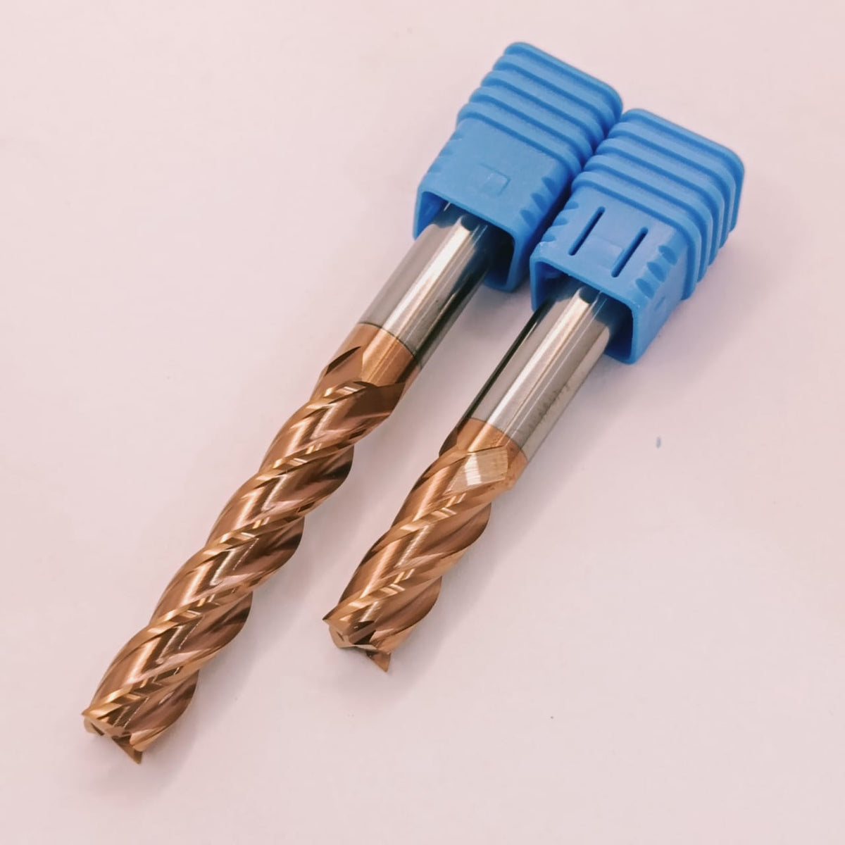 Two metal drill bits with blue handles