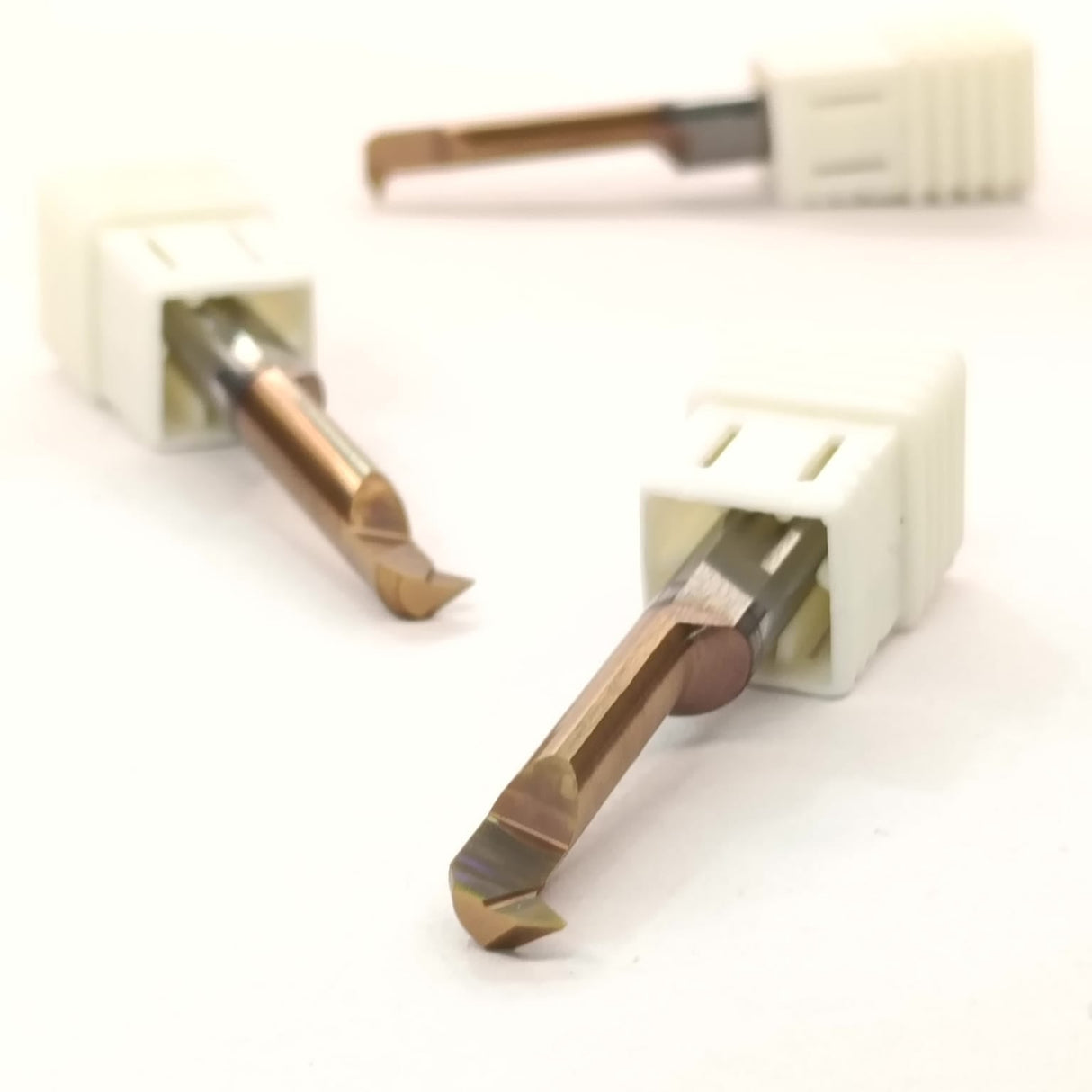 Two metal drill bits with white handles