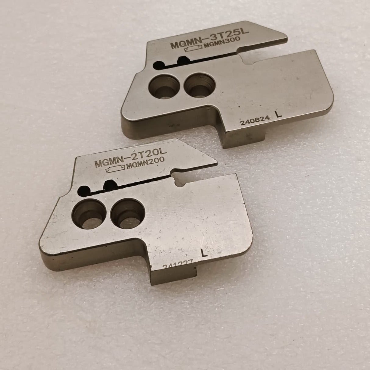Two metal grooving inserts