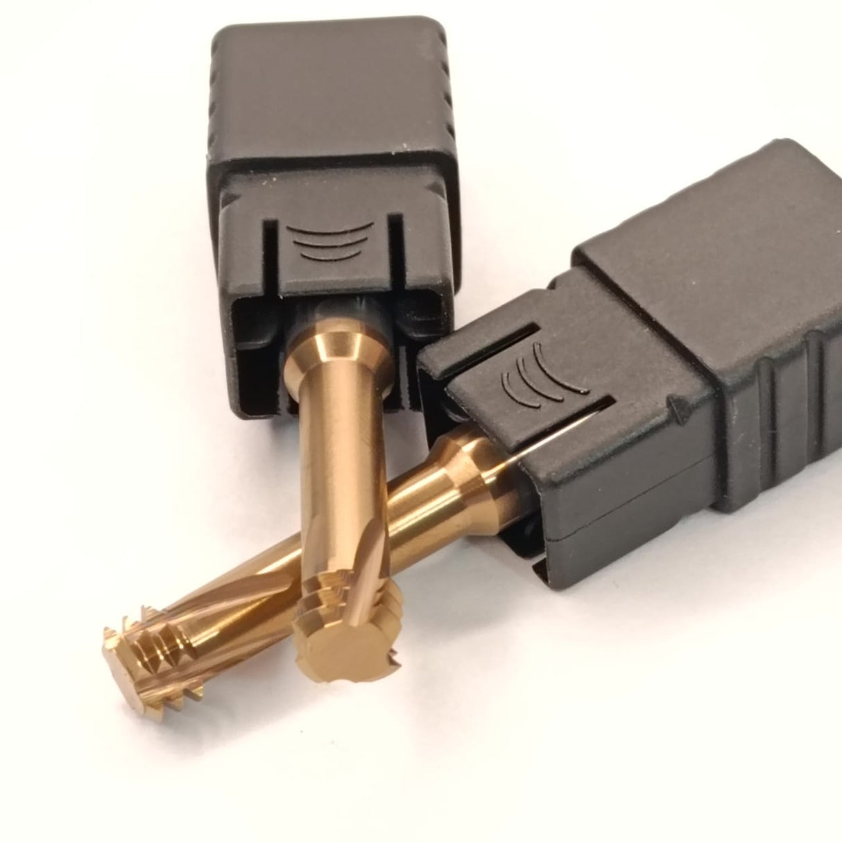 Two gold connectors with black plastic casings 