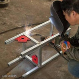 Welder joining metal frame using red magnetic welding clamp