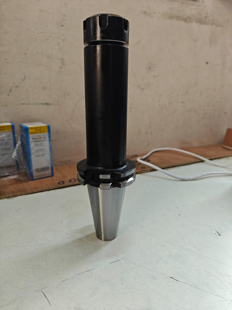 Black cylindrical tool on a light-colored floor 