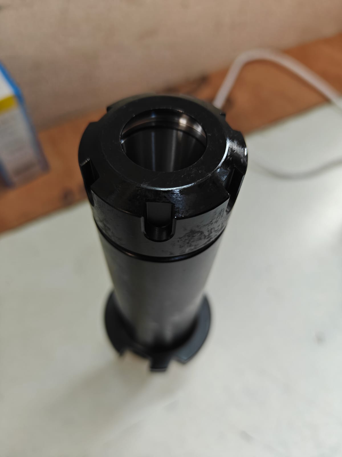 Black cylindrical object on a light surface 