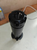 Black cylindrical object on a light surface 