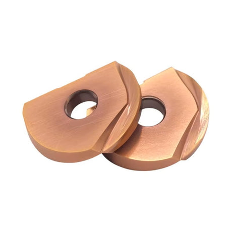 Two copper-colored lathe inserts