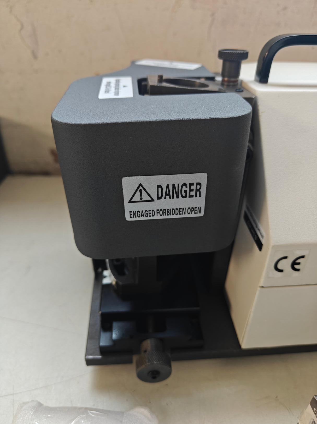 Black machine with a danger label 