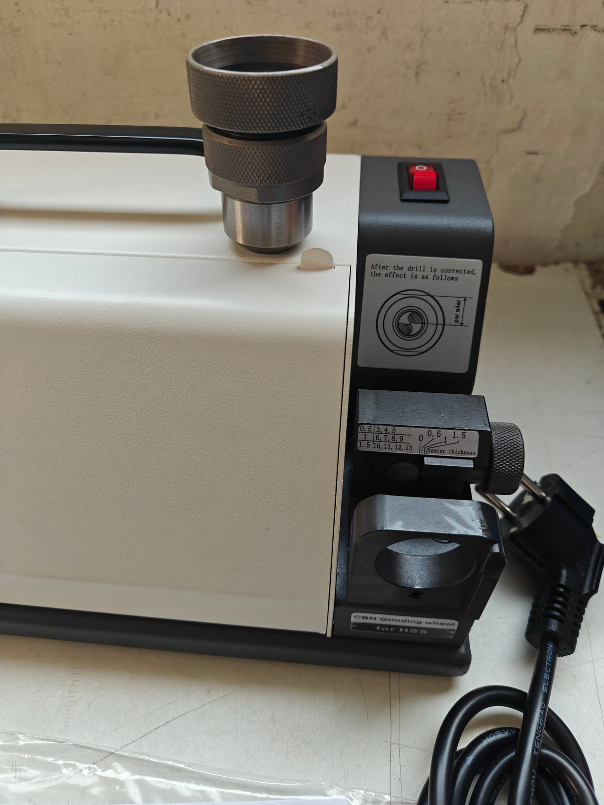 Electrical appliance with a power cord on a tiled floor