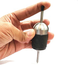 Hand holding universal spring-loaded transfer center punch tool with knurled grip sleeve