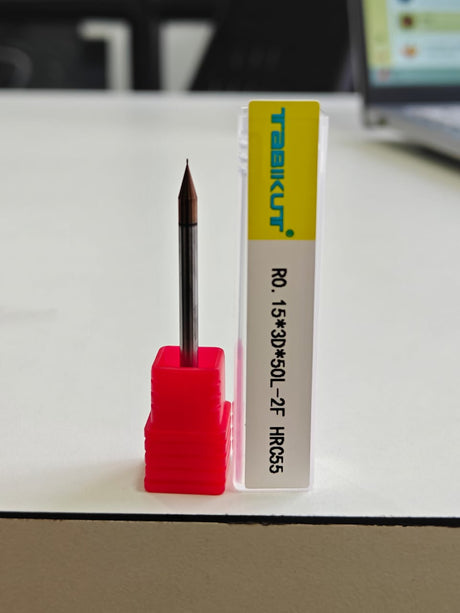 Nail drill bit in a red holder 