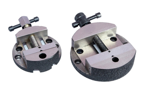 Two circular metal machine vises