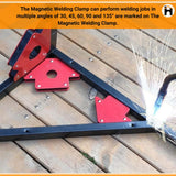 Red magnetic welding clamps holding metal pipes during welding work