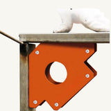 Orange arrow magnetic welding clamp holding metal square tubing