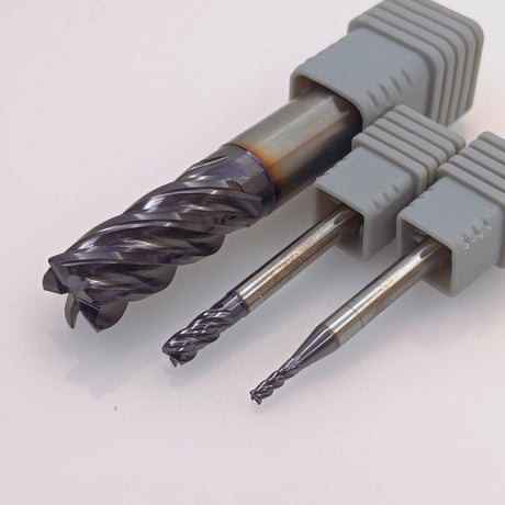 Three industrial carbide end mills