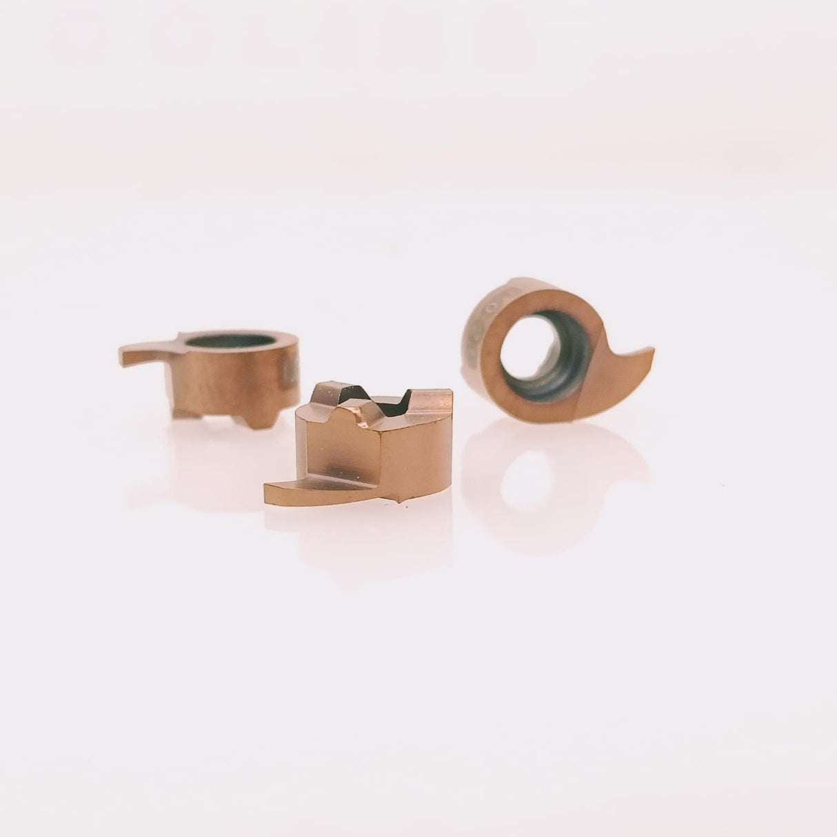 Three carbide cutting inserts